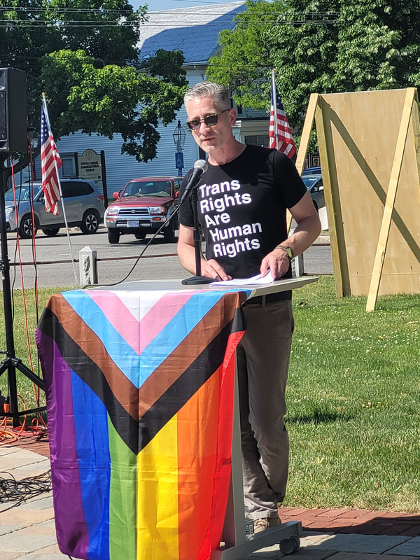 BCCR Emcee David Michael speaks to the crowd. His shirts says, "Trans rights are human rights."