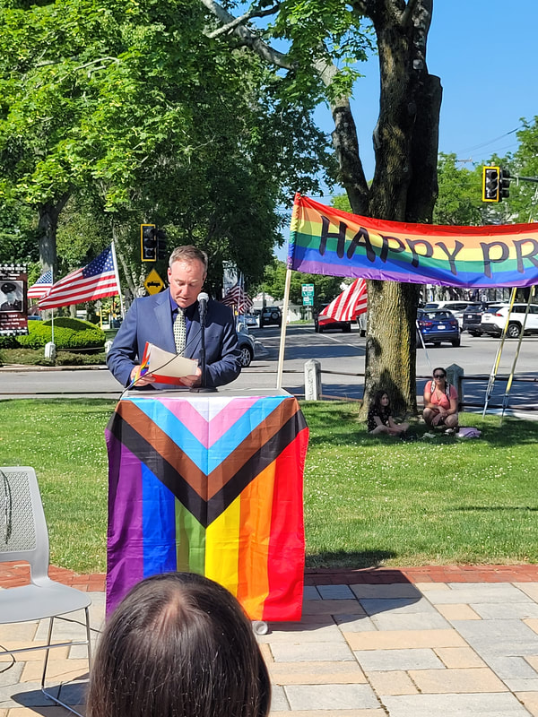 Town Council President Erik Moore reads the 2023 PRIDE Flag Resolution