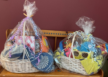 Photograph of raffle baskets on a bench.